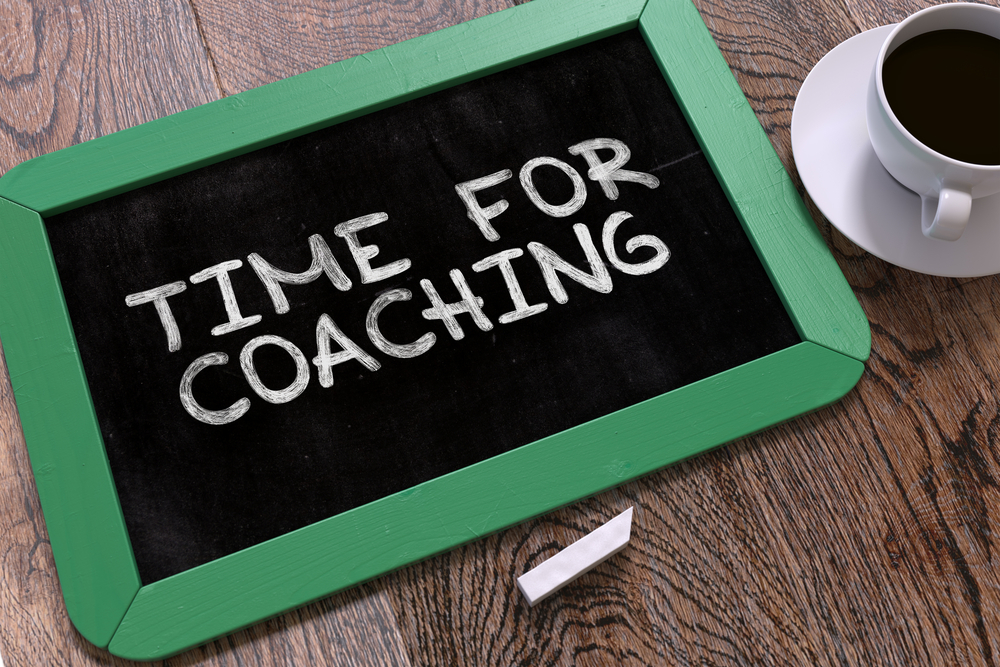 Handwritten Time for Coaching on a Green Chalkboard. Top View Composition with Chalkboard and White Cup of Coffee. 3D Render.